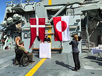 Captain of the Danish navy ship I/F KNUD Rasmussen officiatingat  the wedding of wildlife photographers Helle and Uri Lovevild Golman.  On board the ship I/F KNUD Rasmussen. July 2019