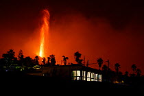 Cumbre Vieja volcano erupting at night, threatening a house in El Paso village, La Palma, Canary Islands, September 2021
