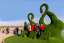 People posing in front of sculpture, Swan Lake, Sanmenxia, Henan province,China.