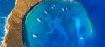 Aerial shot of the inside of the crescent shaped islet with charter boats on moorings, Molokini Marine Preserve, Maui, Hawaii. Seven images were combined for this panorama.