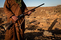 Poacher holding rifle, Aydar, Southern Morocco, Africa, 2020.