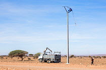 Erecting power lines in the Sahara desert, Southern Morocco, Africa. February, 2020.