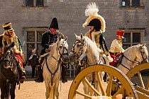 First Empire Military Re-enactment: People dressed in uniform on horseback - from left: Colonel of the Seventh Regiment de Hussards, Second Regiment de Hussards (behind), Chef d&#39;escadron of First...