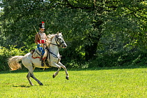 First Empire Military Re-enactment: Man dressed in Second Regiment de Hussards uniform on horseback, Chateau du Plessis-Bourre, Maine-et-Loire, France. July 2021