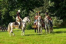 First Empire Military Re-enactment: People dressed in Second Regiment de Hussards (left) and Marechal Murat (left) uniforms on horseback, Chateau du Plessis-Bourre, Maine-et-Loire, France. July 2021
