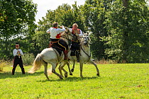 First Empire Military Re-enactment: Man dressed as Chef d&#39;escadron of the First Regiment de chasseur a Cheval de la ligne (right) fighting with a Colonel of the Sixth Regiment de Hussards on Pureb...