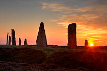 Ring of Brodgar sunset silouhette, Neolithic stone circle, built some 5000 years ago, UNESCO World Heritage Site, managed by Historic Scotland, Orkney, UK, June 2021. Digital composite.