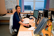 Jacobine Have, an Inuit woman photographed in her office at the hospital at Qaanaaq where she works in administration. Northwest Greenland, 2021.