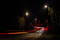 Street lights glowing red at roundabout outside Worcester, England. October.
