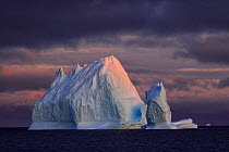 Iceberg on the North Atlantic Ocean in front of Qeqertarsuaq coast, at sunset, Disko island, Greenland, August