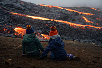 Tourists watching lava flow from eruption of Fagradalsfjall Volcano, Iceland, Europe. June 2021.