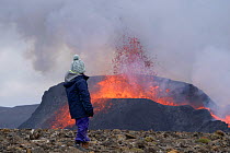 Tourist watching eruption of Fagradalsfjall Volcano, Iceland, Europe. May 2021.