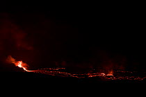 Hot lava spewing from vent within a spatter cone. This feeds a growing lava lake in a pit within the caldera of Halemaumau Crater, Kilauea Volcano, Hawaii Volcanoes National Park, Hawaii Island, Hawai...