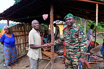 Ecoguard on a routine patrol, visiting a village within the boundaries of the national park, Conkouati-Douli National Park, Republic of Congo, Africa.