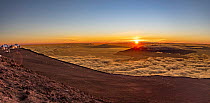 View from the summit of Haleakala, a dormant volcano, at sunset. The observatories, collectively known as Science City are on the far left, Haleakala National Park, Maui, Hawaii. July, 2021.