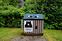 A bear-proof rubbish bin that reads "A fed bear is a dead bear!" in a public park, Vancouver Island, British Columbia, Canada. June, 2021.