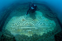 Scuba diver observing a mosaic discovered in 2020. It is the second submerged polychrome mosaic in the world, Underwater Archaeological Marine Park of Baia, Naples, Italy, Mediterranean Sea. September...