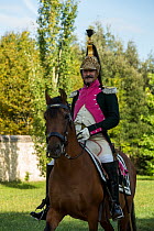 Major from the 18th Regiment of Dragons de la Ligne mounted on PRE horse. First Empire reenactment for the bicentenary anniversary of Napoleon Bonaparte's death, Chateau de Versailles, France.  2...
