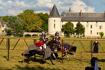 Two men in medieval knight costume on horseback, in armour, jousting, Chateau du Plessis-Bourre, Loire Valley, France. 2021