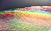 Jet stream winds high above the Annapurna Himalayas creating clouds with rainbow colours caused by light refraction on ice crystals, known as parhelion or sundog, in Nepal, South Asia. December, 2012.