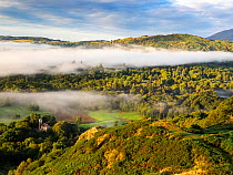 Mist at dawn over the Langdale Valley, looking down on Brathay church, Lake District National Park, Cumbria, UK. September, 2021.