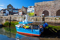 Small fishing boat moored in Seahouses harbour, Northumberland, UK. May, 2021.