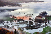 View of flooded water meadows and mist over Lake Windermere from Todd Crag at sunrise, Lake District National Parkc Cumbria, UK. November, 2020.
