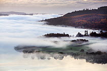 View of mist over Lake Windermere from Todd Crag at sunrise, Lake District National Park, Cumbria, UK. November, 2020.