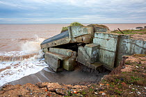 Remains of the Godwin Artillery Battery, initially constructed in the First World War, on the beach at Kilnsea, Spurn Point, Yorkshire, North Sea, UK. October, 2020.