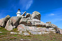 Lighthouse and granite boulders, Peninnis Head, St Mary's, Scilly Isles, UK. September, 2020.