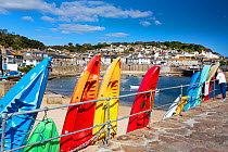 Kayaks along the harbour wall, Mousehole, Cornwall, UK. September, 2020.