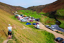 Campervans and wild campers near Coombe on the Cornish coast, during the Covid pandemic, Cornwall, UK. September, 2020.