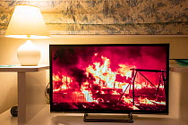 Television screen showing BBC news covering the devastating wildfires in California exacerbated by climate change, UK. September, 2020.