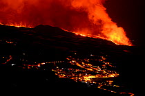 Lava flow and ash from erupting volcano passing close by the village of Los Llanos de Aridane, Volcano Cumbre en Vieja, La Palma, Canary Islands. November, 2021.