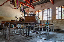 Child, named David, in empty converted primary school classroom after Cyclone Idai. Outskirts of Gorongosa National Park, Mozambique.  March 2019.