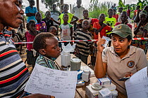 Nurse Berta Barros, dispensing medication to community members in Momba community in park's buffer zone during Medecins Sans Frontieres visit after Cyclone Idai. Outskirts of Gorongosa National P...