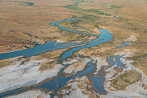Water flows into Lake Eyre South from small local rivers that have come alive as a consequence of uncommonly high recent local rainfall. Salt pan edge visible and greening desert. Lake Eyre South, Sou...