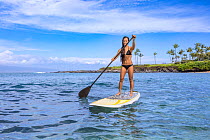 Girl on stand-up paddle board, Kapalua Bay, Maui, Hawaii. Pacific Ocean. Model released.