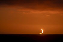 A total solar eclipse on the horizon over the Southern ocean between South Georgia and the Falkland Islands. 4 December, 2021.