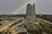 Rainbow over Parys Mountain (Mynydd Parys) windmill at abandoned copper mine workings near Amlwch, Anglesey, Wales, UK. July, 2018.