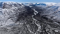 Aerial view of braided river running through valley on snow covered plateau, Putoransky State Nature Reserve, Putorana Plateau, Siberia, Russia. May, 2021.
