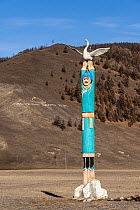 Traditional tribal wooden totem pole of the Buryats people, Kropotkin Ridge. Eastern Sayan, Buryatia, Siberia, Russia. October, 2020.