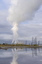 Plume of steam rising from cooling towers at the  Flint gas fired power station drifting over Flintshire Bridge, River Dee, North Wales, UK. November, 2021.