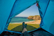 Camping in summer -  view from inside a tent, looking out over coastline, Isle of Lewis, Outer Hebrides, Scotland, Atlantic Ocean, UK. June, 2016.