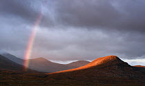 Rainbow and stormy sky over the Fannichs mountain range, Ullapool, Highlands, Scotland, UK. September, 2018.
