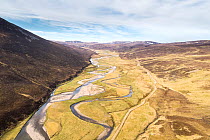 Aerial view of the upper River Dulnain running through open moorland, Monadhliath mountains, Highlands, Scotland, UK. May, 2020.