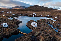 Bags of mulch and dams holding back water as part of peatland restoration works, Mar Lodge Estate National Nature Reserve, Cairngorms National Park, Scotland, UK. November, 2021.