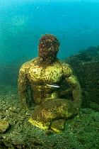 Ancient Roman statue depicting companion of Ulysses, perhaps Baio, located in submerged Nymphaeum of Emperor Claudius. Marine Protected Area of Baia, Naples, Italy. Tyrrhenian sea. Encrusted with barn...