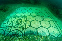 Ancient Roman tessellatum mosaic in black and white decorated with pattern of hexagons, perfectly preserved, in Villa a Protiro. Marine Protected Area of Baia, Naples, Italy. Tyrrhenian sea.