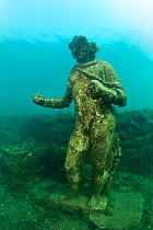 Ancient Roman statue of Dionysus with ivy crown, located in submerged Nymphaeum of Emperor Claudius. Marine Protected Area of Baia, Naples, Italy. Tyrrhenian sea.